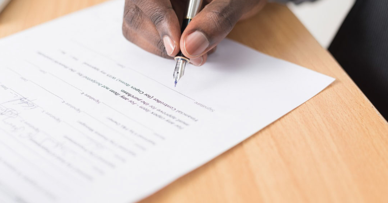 man signing shipping contract